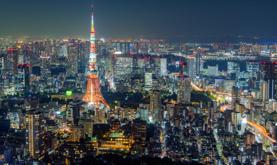 Tokyo skyline illuminated by Tokyo Tower, where accommodation tax applies to hotels and stays