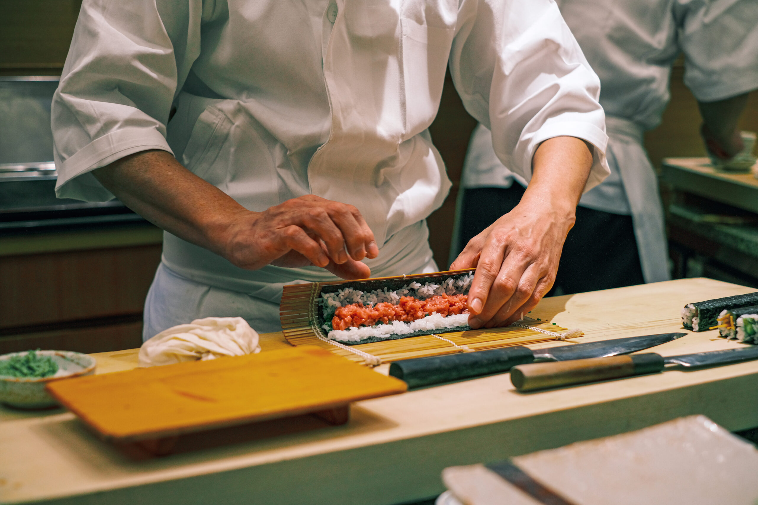 Chef preparing sushi on a counter