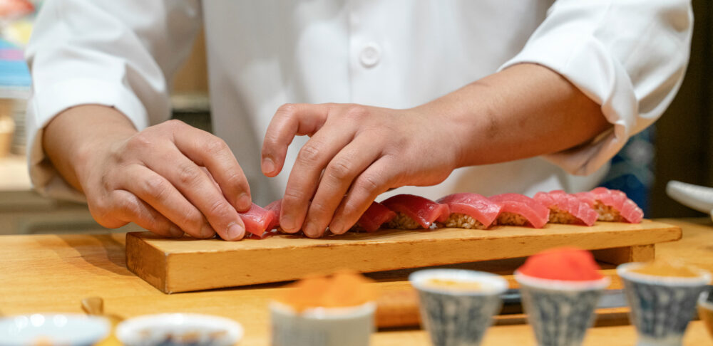 Japanese Sushi Chef making Bluefin Tuna Sushi. Omakase sushi course.