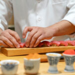 Japanese Sushi Chef making Bluefin Tuna Sushi. Omakase sushi course.