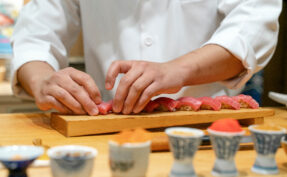 Japanese Sushi Chef making Bluefin Tuna Sushi. Omakase sushi course.