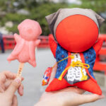 Red Sarubobo Dolls and Ice Cream at Miyagawa Morning Market in Takayama, Japan.