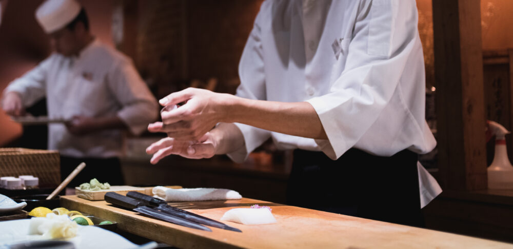 Chef preparing sushi, squeezing rice, fast motion in hands. Omakase style Japanese traditional.