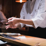 Chef preparing sushi, squeezing rice, fast motion in hands. Omakase style Japanese traditional.