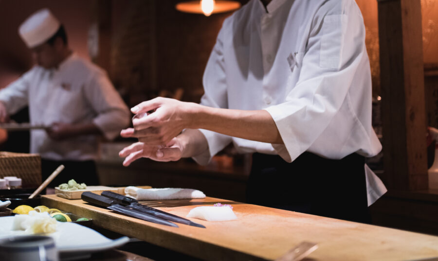Chef preparing sushi, squeezing rice, fast motion in hands. Omakase style Japanese traditional.