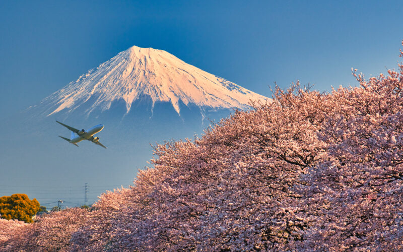 Airplane flying by Mount Fuji