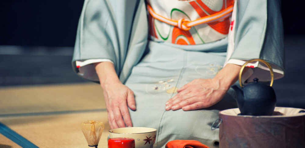 Woman with light blue kimono during a traditional tea ceremony