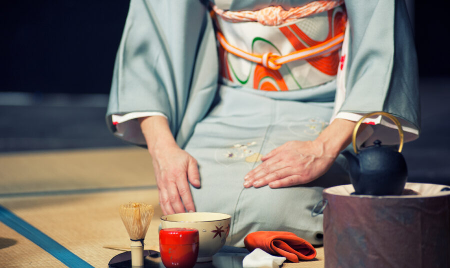 Woman with light blue kimono during a traditional tea ceremony